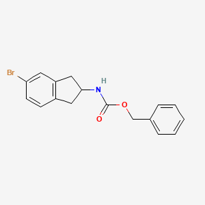 molecular formula C17H16BrNO2 B8134020 benzyl N-(5-bromo-2,3-dihydro-1H-inden-2-yl)carbamate 