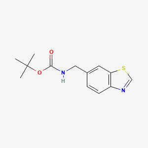 molecular formula C13H16N2O2S B8146653 tert-Butyl (benzo[d]thiazol-6-ylmethyl)carbamate 