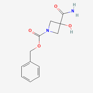 molecular formula C12H14N2O4 B8221663 Benzyl 3-carbamoyl-3-hydroxyazetidine-1-carboxylate 