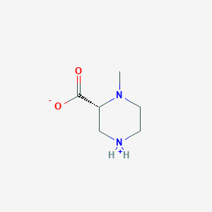 molecular formula C6H12N2O2 B8229552 (2R)-1-methylpiperazin-4-ium-2-carboxylate 
