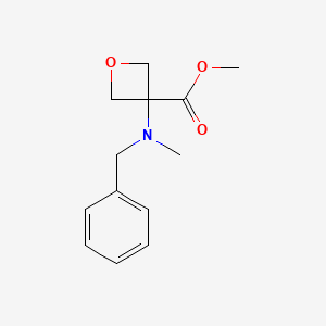 molecular formula C13H17NO3 B8248713 Methyl 3-[benzyl(methyl)amino]oxetane-3-carboxylate 