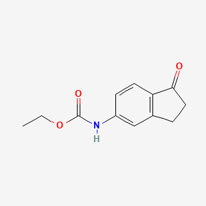 molecular formula C12H13NO3 B8443290 5-Ethoxycarbonylaminoindan-1-one 