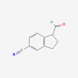 molecular formula C11H9NO B8456200 1-Formylindane-5-carbonitrile 