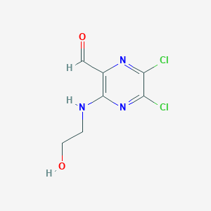 5,6-Dichloro-3-[(2-hydroxyethyl)amino]pyrazine-2-carbaldehyde