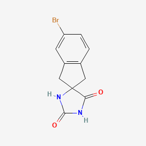 5'-Bromo-1',3'-dihydrospiro[imidazolidine-4,2'-indene]-2,5-dione