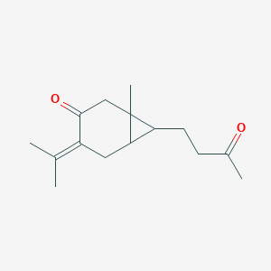 molecular formula C15H22O2 B009321 1-methyl-7-(3-oxobutyl)-4-propan-2-ylidenebicyclo[4.1.0]heptan-3-one CAS No. 100347-96-4